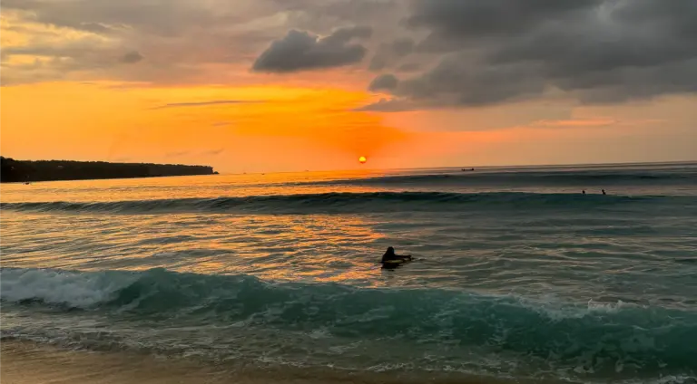 Dreamland beach uluwatu by sunset with surfer
